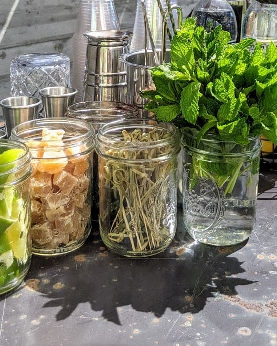 Organized bar station with mint jar, garnish jars, and bar mat
